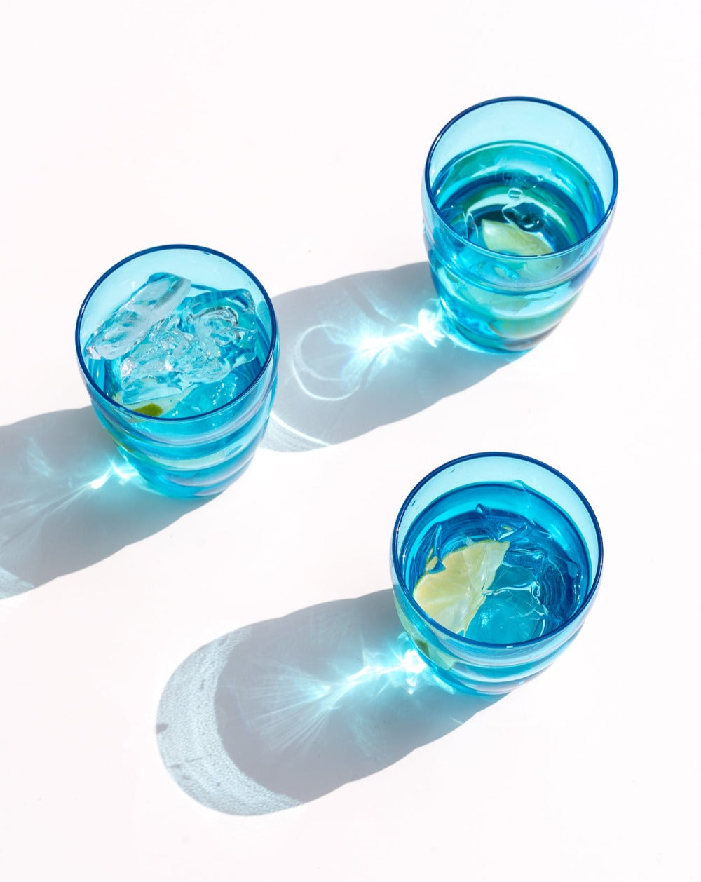 Aqua Turquoise Ripple Glass Tumblers shining in the sunshine